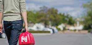 A SAC student walking with a gas container