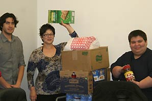 Representatives of Occupy Orange County display and holding dry food donated.