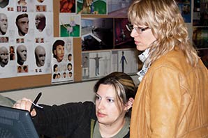 Professor Patricia Waterman shows student Elizabeth Cordova how to use the digital drawing boards in the new Animation lab.