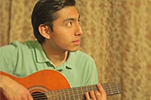 Jose Angel Altamirano in a relaxed mood playing his guitar.