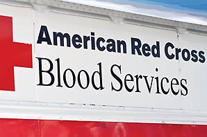 The side panel of American Red Cross Blood Services mobile with the red cross symbol.