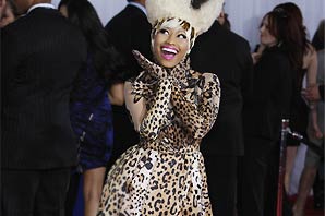 Nicki Minaj arrives for the 53rd Annual Grammy Awards show at the Staples Center in Los Angeles, California on February 13, 2011, wearing a fluffy white fur or fur-like hat with black strip, leopard print dress with matching long gloves and leotard.