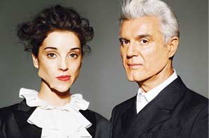 The album cover for David Byrne & St. Vincent with portraits of the two group members. They were both wearing suite with white shirt. St. Vincent mouth is visibly filled with some very odd objects.