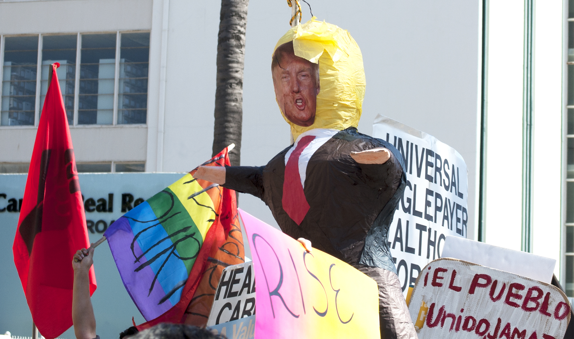 A Donald Trump Piñata floats above the crowd.