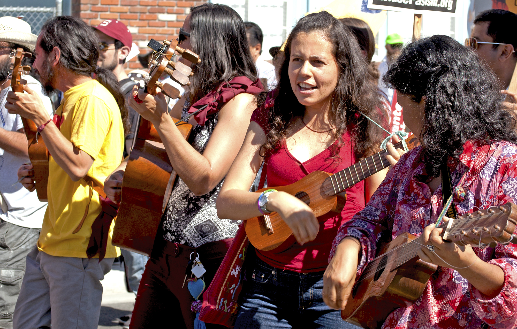 Musicians singing in Spanish lead the people in song.