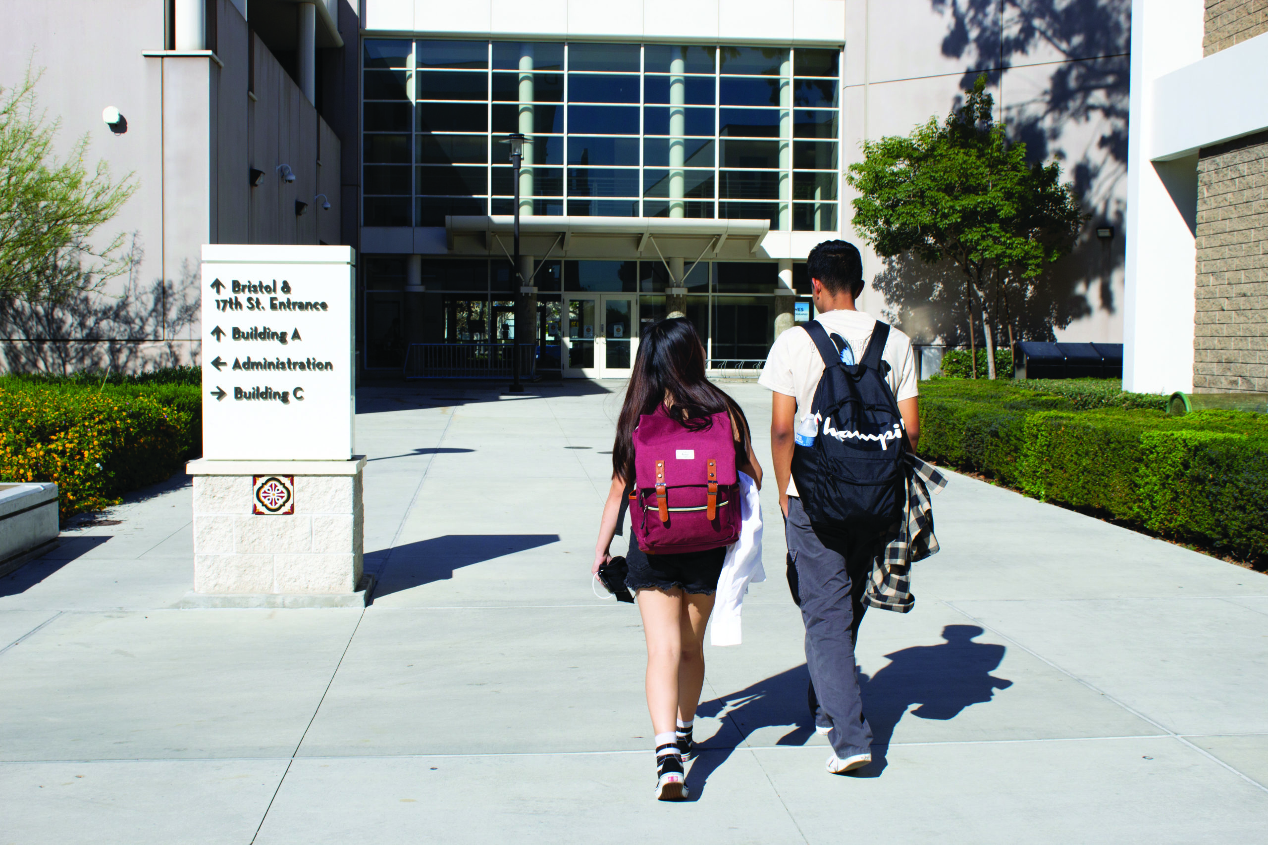 a male and female student wearing walk through the Santa Ana college campus