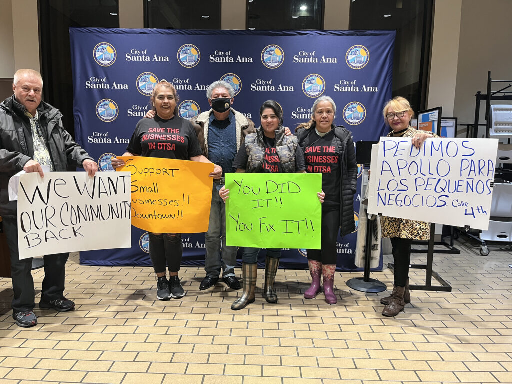 Business owners protesting at city council meeting.