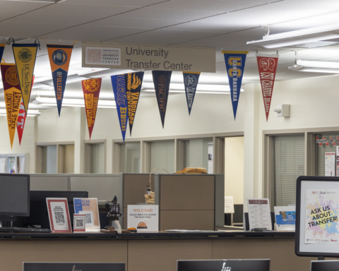 Transfer center check in desk displays the flags of the colleges most frequently transferred to .