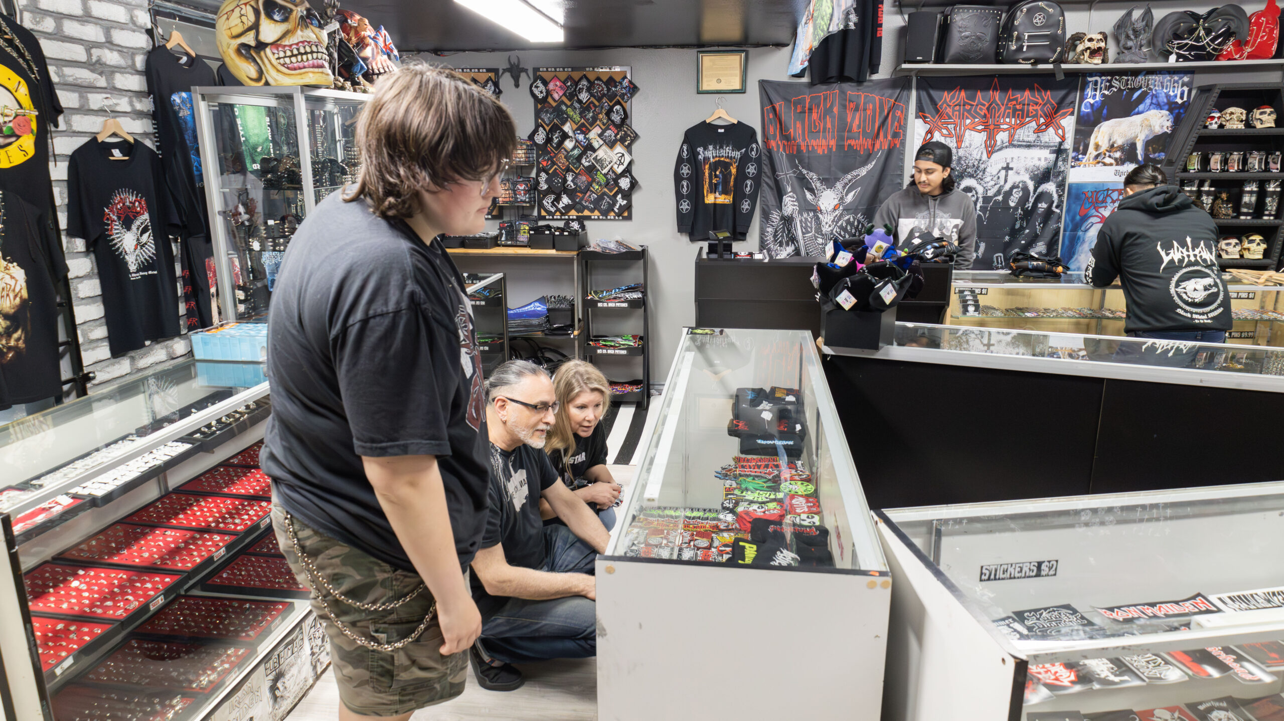 Customers looking at a display case of patches