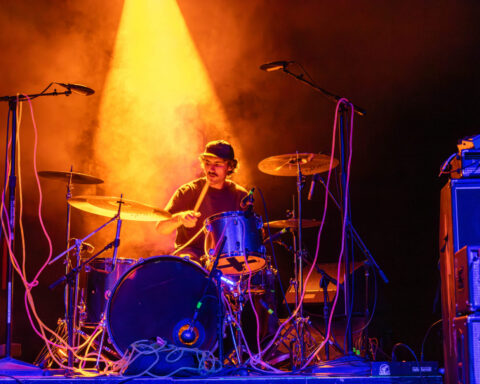 A drummer under orange light
