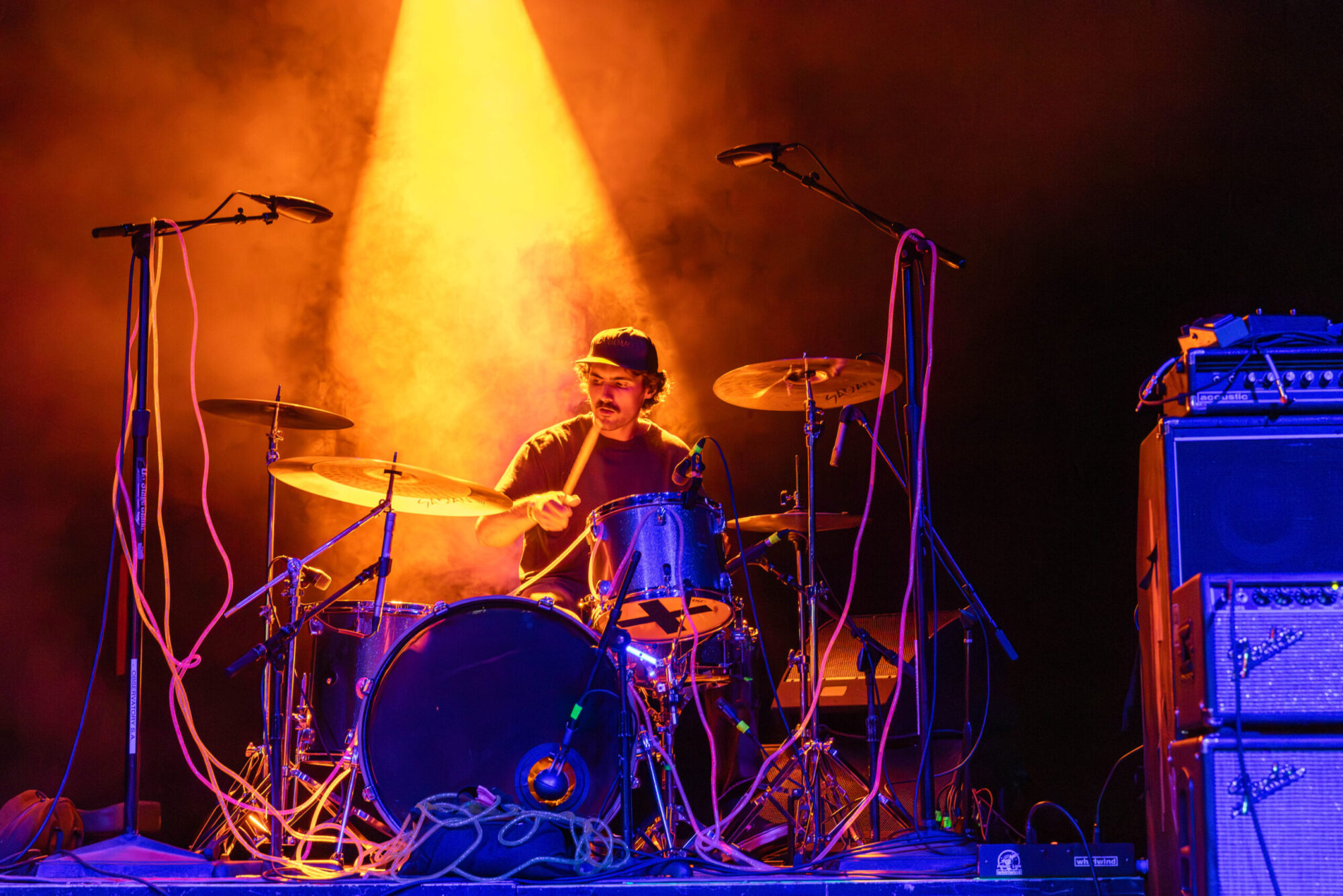 A drummer under orange light