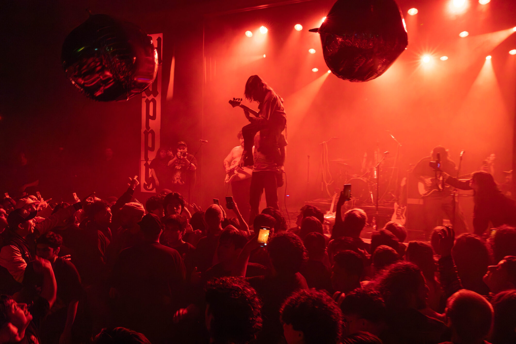 A band performing under red light