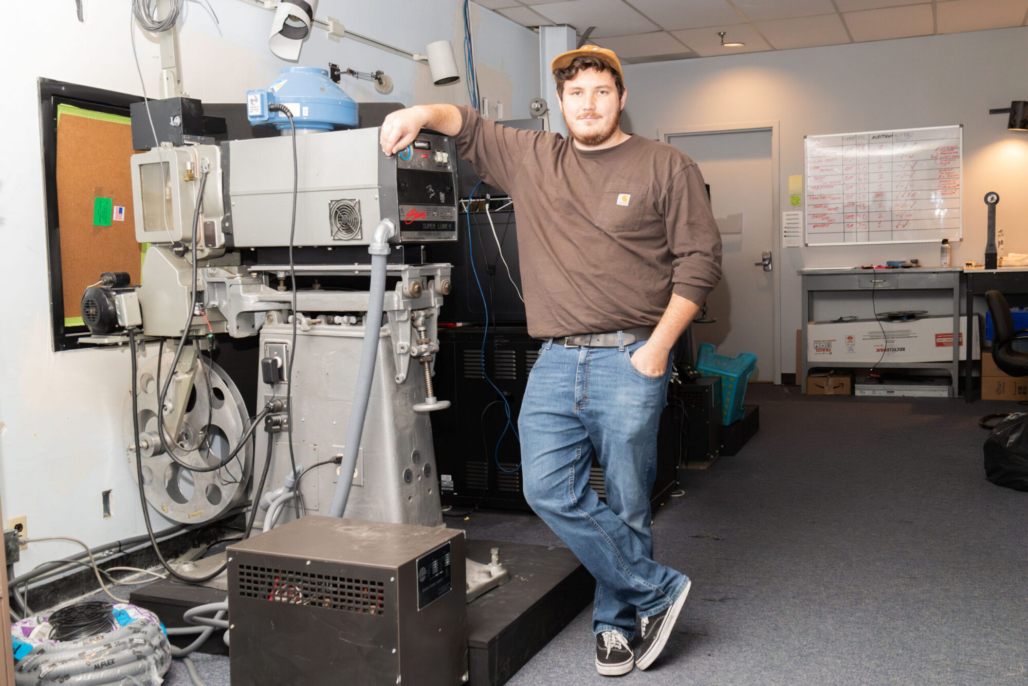 Man standing next to a movie projector