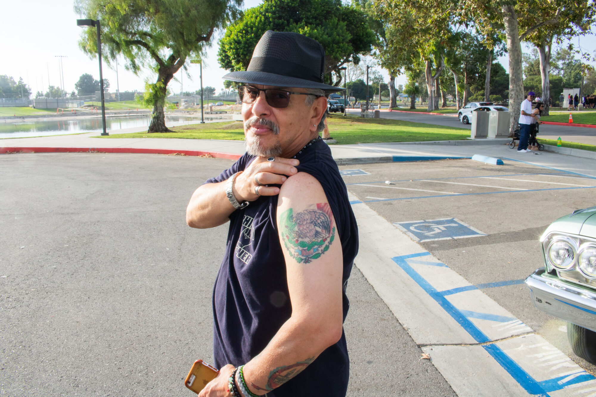 A man showing his upper arm tattoo of the Mexican flag