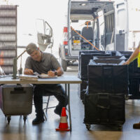 Two workers sorting ballots at the voting center