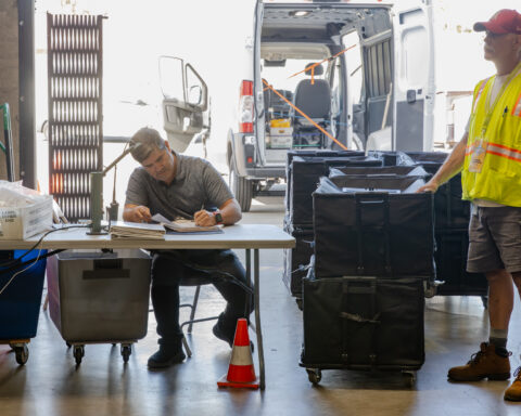 Two workers sorting ballots at the voting center