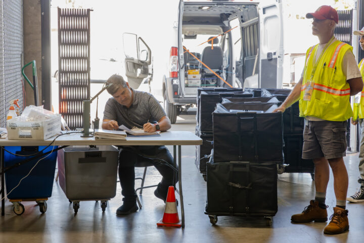 Two workers sorting ballots at the voting center