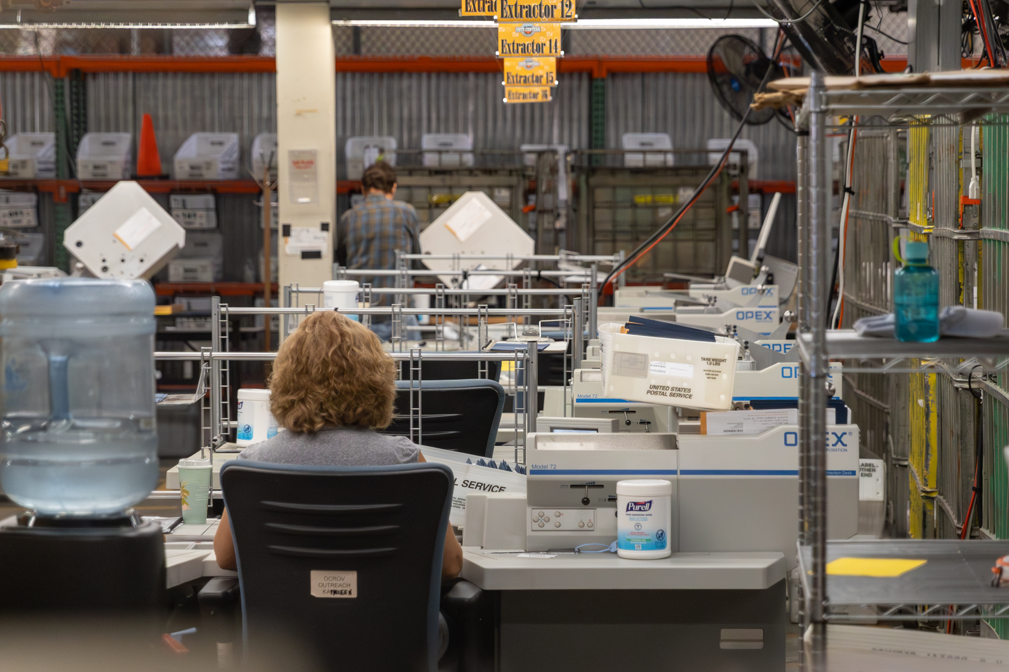 Ballots moving through an extractor device