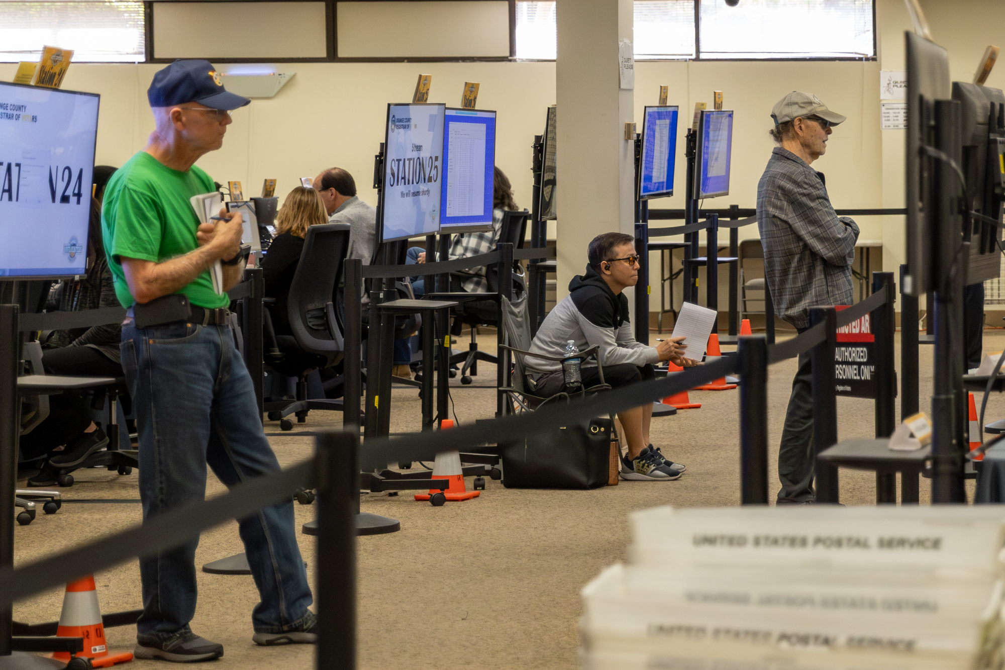 People observing and taking notes on the signature verification process