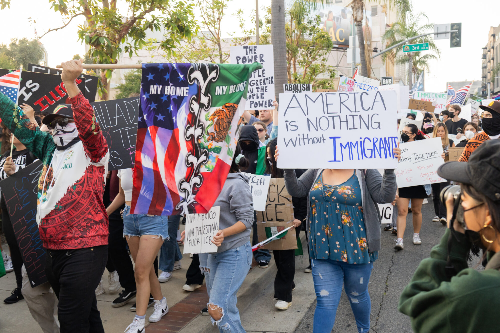 A crowd protesters with signs and flags