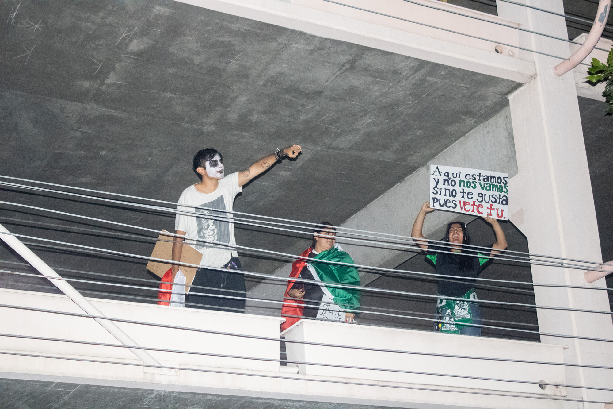 People shouting from a parking structure