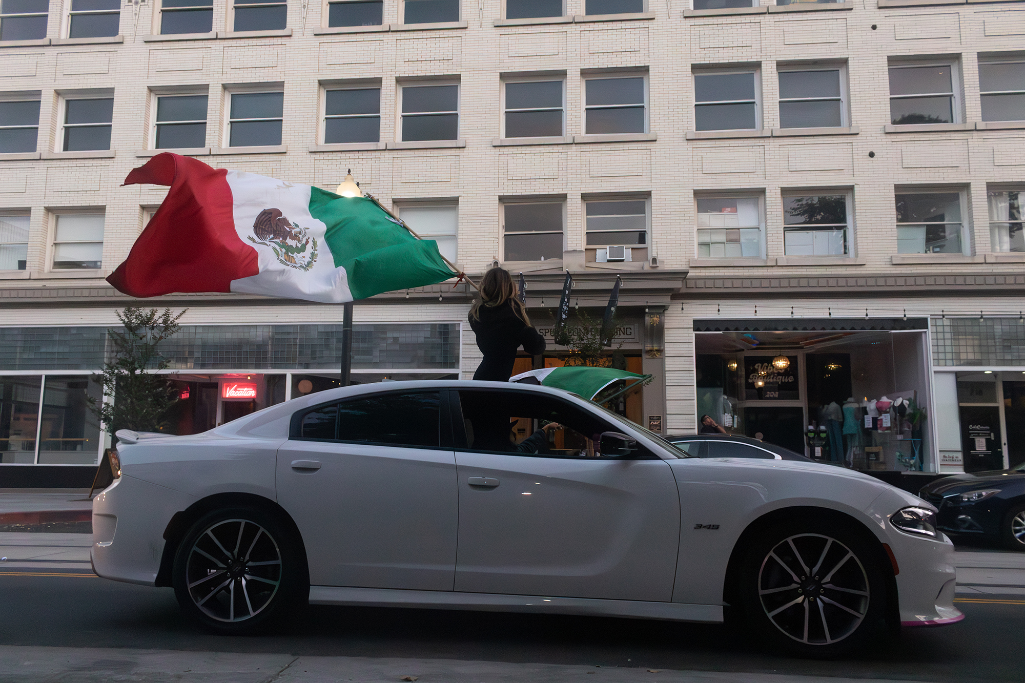 Waving a Mexican flag out of a sunroof
