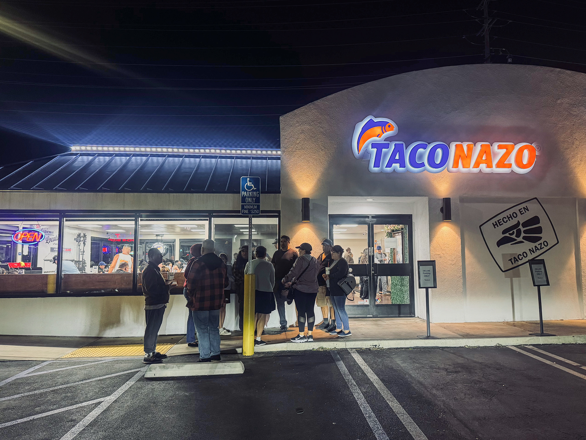 A group of people standing outside the new Taco Nazo location in Santa Ana.