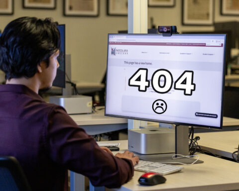 A student looking at a web page with big 404 in the middle of the screen.