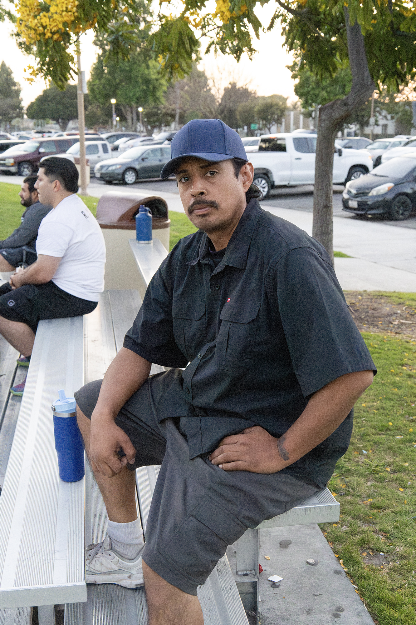 A man sitting on a bench at a park