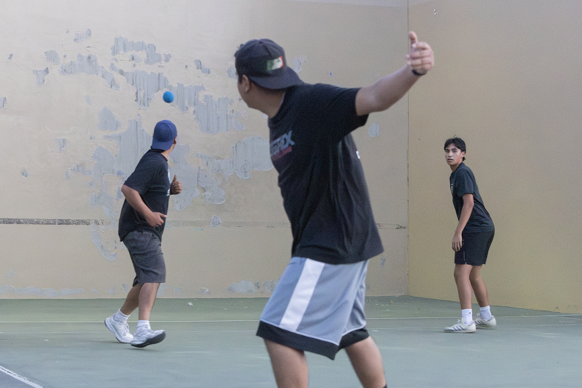 Three men playing handball